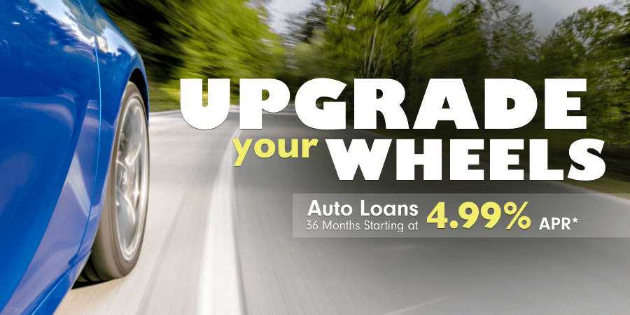 Side panel view of a car driving on a winding road. At the right, the words: upgrade your wheels auto loans 36 months starting at 4.99% apr*