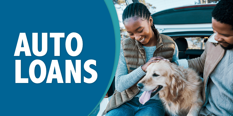 An African American couple sitting in the trunk of their car petting their smiling dog. At the left, the words: auto loans