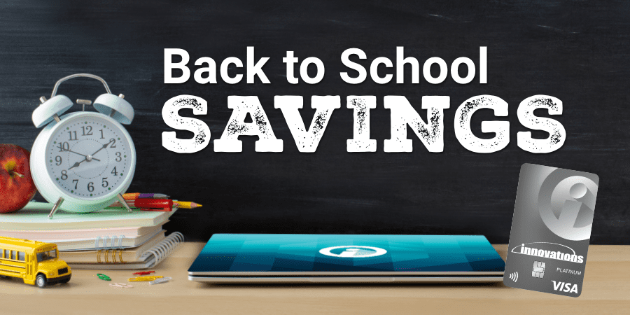 An up close classroom scene with a laptop, books, pencils, and clock on top of a desk with a chalkboard in the background. Across the middle, the words: back to school savings.