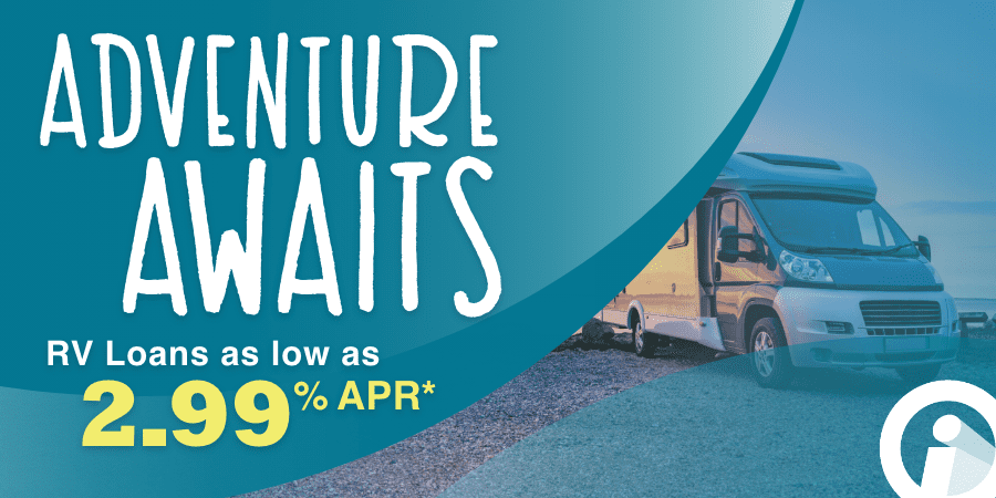 An RV parked on a shoreline. At the left, the words: adventure awaits rv loans as low as 2.99% APR*