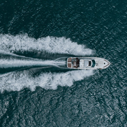 Top view of a boat making waves in the water.