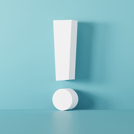An exclamation mark with a drop shadow against a teal background.