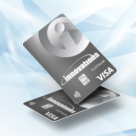 Two Innovations Visa credit cards against a pattern background.