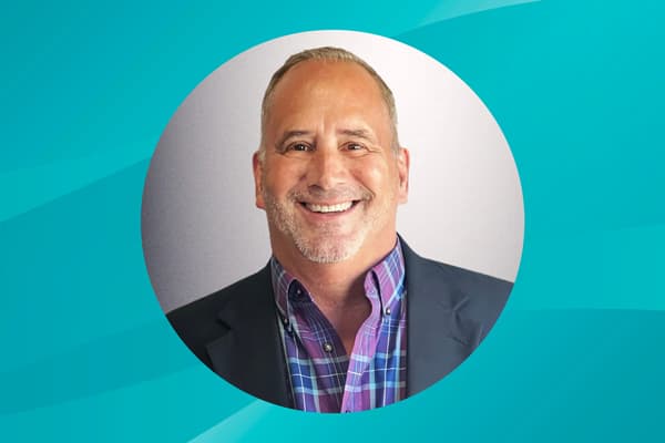 Profile of Craig Ellis against a patterned background.