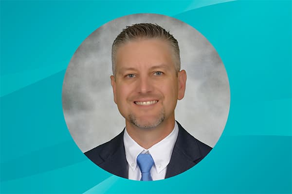 Profile of Jeremy Wood against a patterned background.